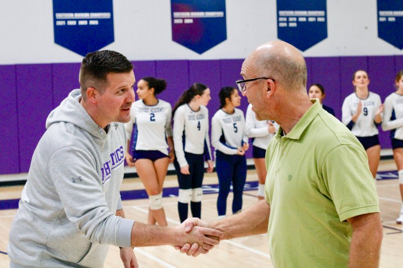 Head of School Kyle Bentley shakes hands with Michael Schaefer.