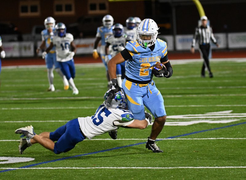 Cape running back Dell Richards drags Hawks’ junior Shiloh Mull for a first down.