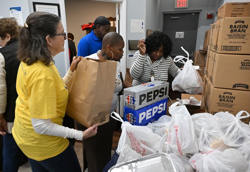 Volunteers prepare the food bags.