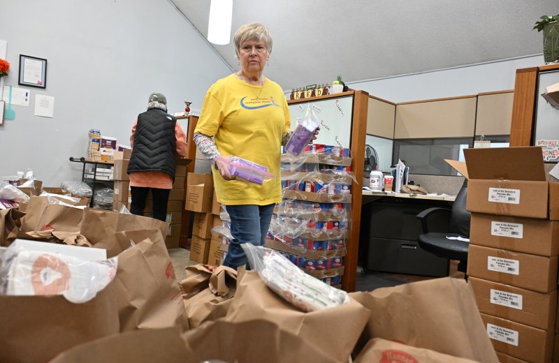 Deb Norton of Westminster Presbyterian Church fills the packages for the giveaway.