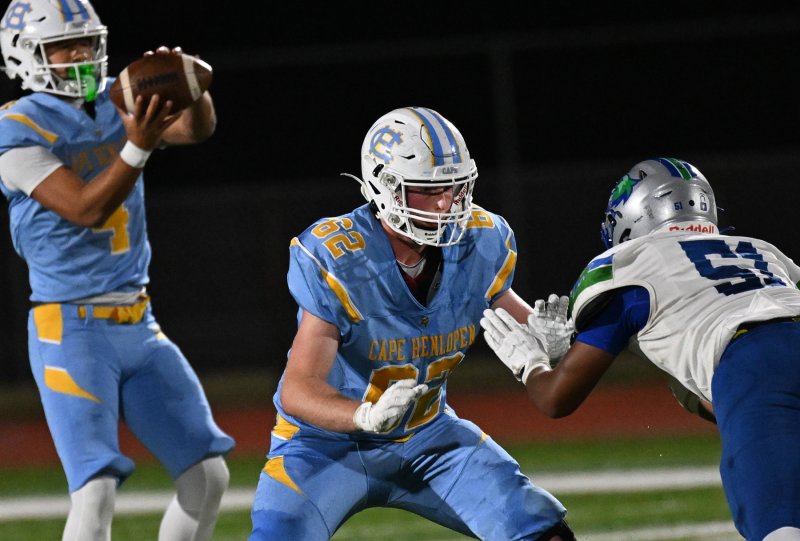 Cape’s Liam Ramsey, center, pass blocks for Cape quarterback Jameson TIngle.