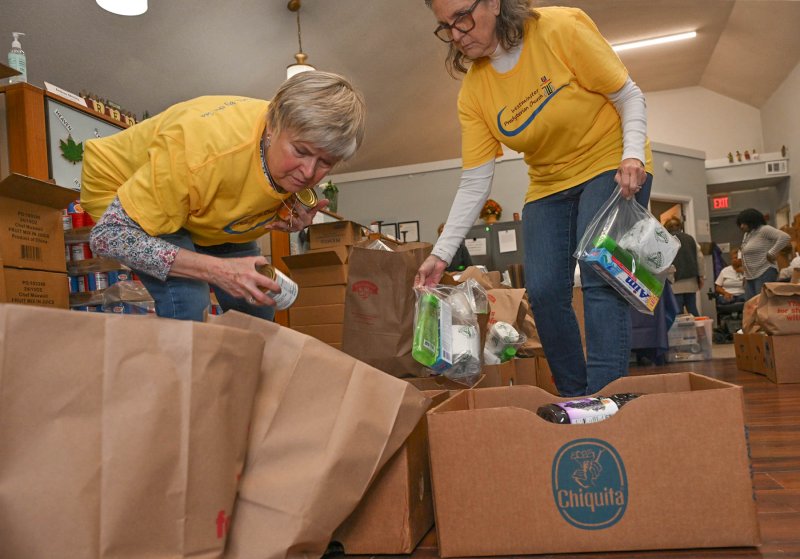 Deb Norton, left, and Kathy McIndoe of Westminster Presbyterian Church fill packages to be distributed.