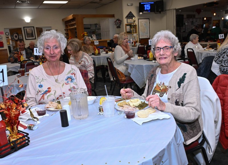 Enjoying the annual Thanksgiving meal are friends Victoria Drake, left, and Carol Hutson.