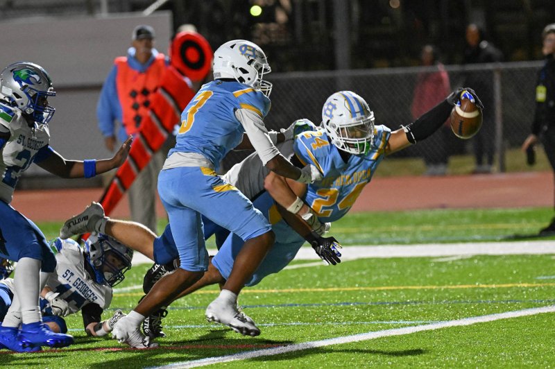 Dell Richards dives in for the go-ahead score in the 28-23 win over St. Georges. DAN COOK PHOTOS