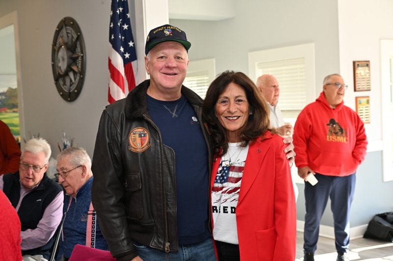 Navy veteran Scott Stewart stands with his wife Terry before the ceremony. Terry read the Missing Man Table dedication.