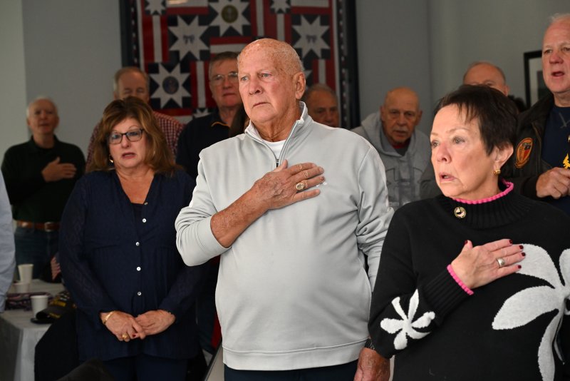 Honoring the flag during the national anthem are (l-r) Lori Weaver, Don Dalton and his wife Eileen.