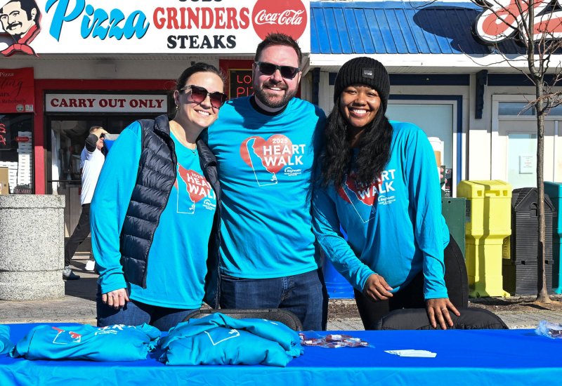 Working the Heart Walk swag booth are (l-r) co-chairs Sarah Neely-Collins, Ben Collins and Dawenda Dorciun-Mannings.