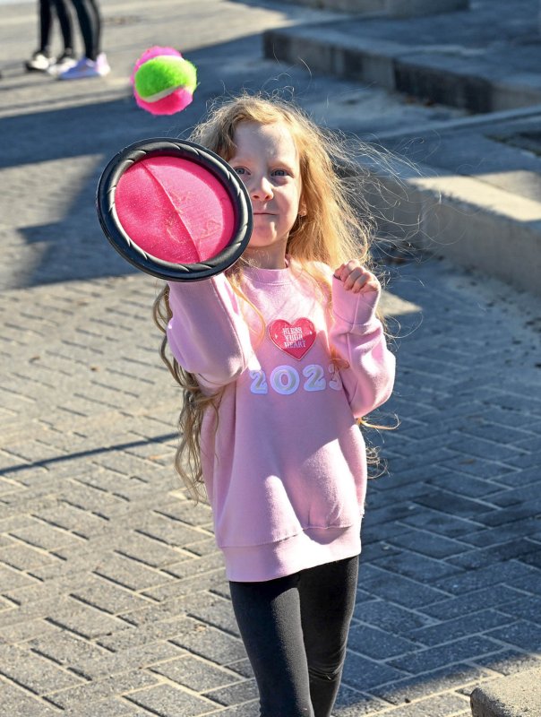 Lilly Steele, 7, plays catch in the Heart Walk Kids Zone.