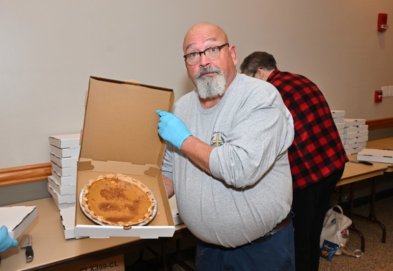 Randy Ellis displays the delicious pies used for the dessert packages.