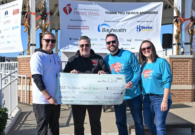 Presenting a check for $26,000 to the American Heart Association of Delaware from TKo Hospitality are (l-r) Drew DiFonzo, vice president of operations for TKo Hospitality; Jim Murphy, executive director for the American Heart Association of Delaware; and walk co-chairs Ben and Sarah Collins.