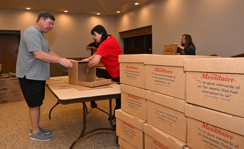 Jeff and Maria Brice work together to build boxes donated by Mountaire.
