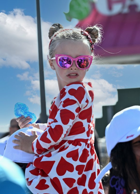 Carleigh McGreevy, 5 1/2, has a good seat for the event.