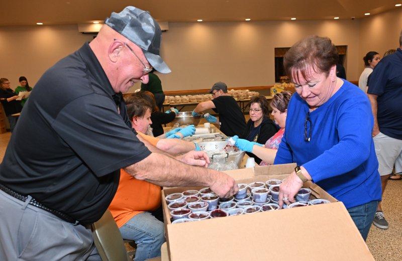 Millsboro Mayor Bob McKee, left, and his wife Maureen fill a cranberry sauce box.