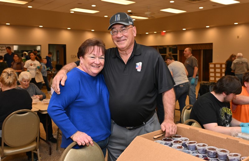 Millsboro Mayor Bob McKee, right, and his wife Maureen work at the cranberry sauce table.