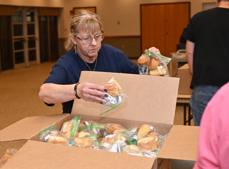 Blessings for Badges President and founder Cindi Susi stacks the bread and butter packages.