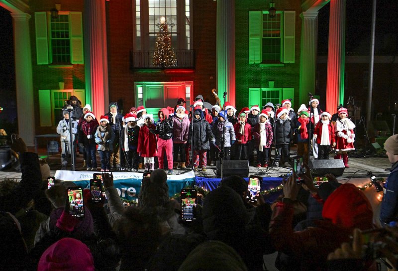 Loved ones and friends alike grabbed their cellphones and recorded the 2024 performance of the Children’s Choir of St. Michael’s Catholic Church at the annual Caroling on The Circle. DAN COOK PHOTO
