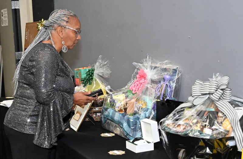 Rosalyn Winder makes a bid at the silent auction.