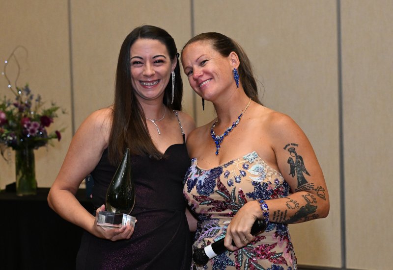 Bri Townsley, left, receives the Ride or Die Award from Grass Roots Rescue founder Karli Crenshaw.