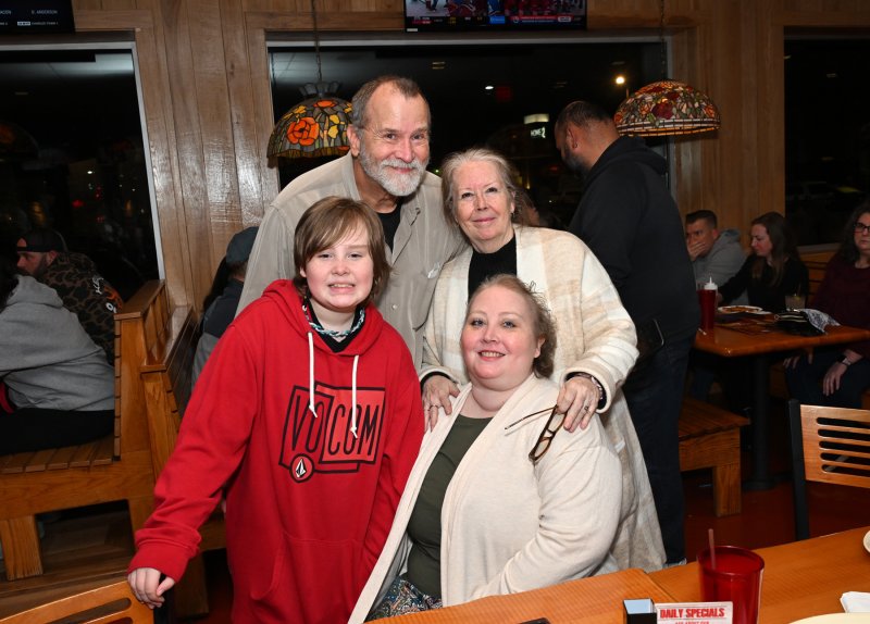 Katie Arietta sits with her son Logan, 10, and parents Michael and MaryLou Elrod. DAN COOK PHOTOS
