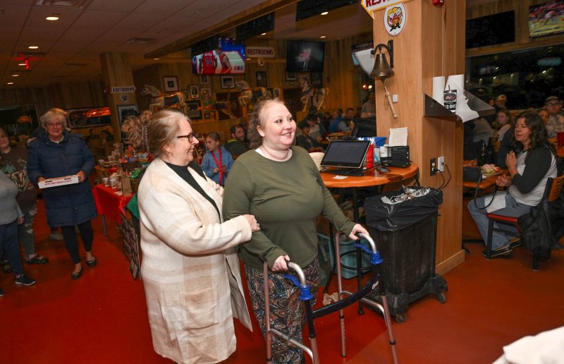 KAtie Arietta’s mom, MaryLou Elrod, helps her out of Nicola and back to the hospital.