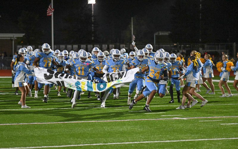 Cape senior Dell Richards leads his teammates on the field of battle with the Hawks.