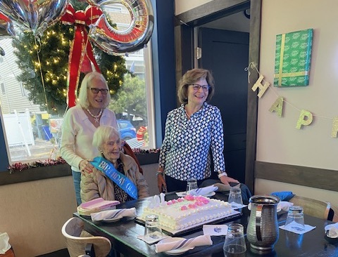 Bonnie McCarthy, front, is ready to cut her 105th birthday cake. Behind her are (l-r) her friend Ellen Winkler and daughter Dale Cummings.