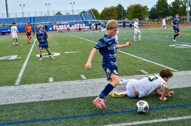 Sussex Academy senior Noah Benz bends around his defender.
