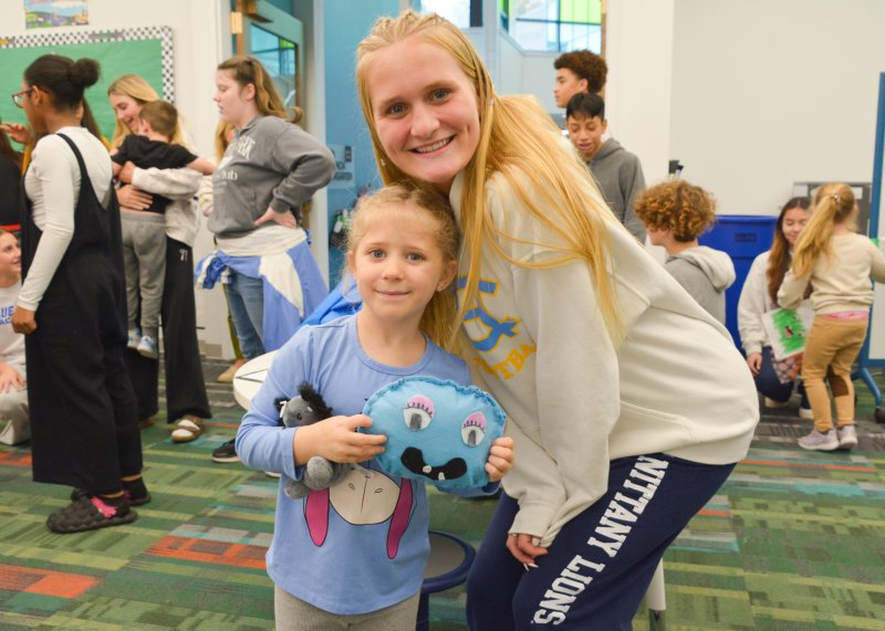 Fred Thomas Middle School student Finley Tuer pauses for a photo with Lewes Elementary kindergartener Analia Dominick after giving her the monster.