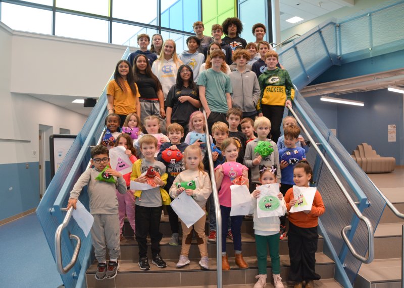 Lewes Elementary kindergartners show off their monsters and original drawings as the project with Fred Thomas Middle School students wraps up.