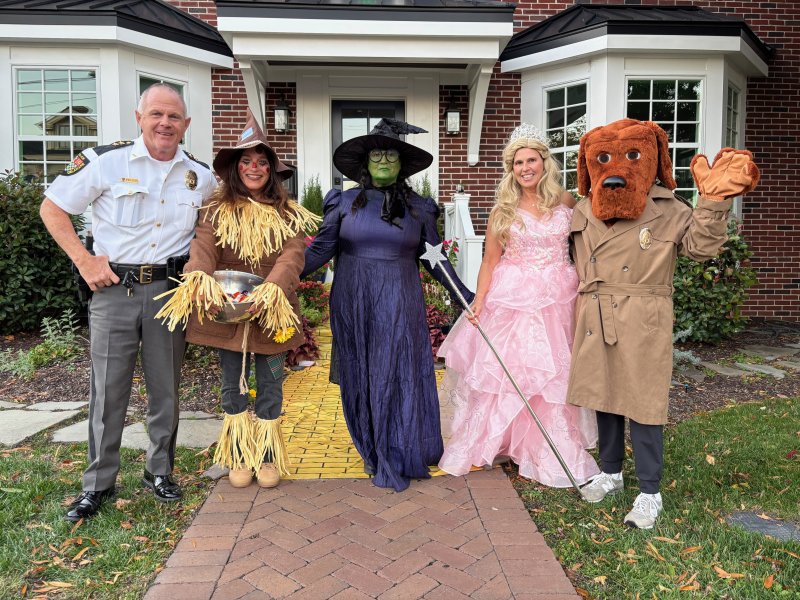 McGruff the Crime Dog, right, makes the rounds during trick-or-treating. He and Lewes Police Chief Tom Spell, left, stop to greet Eva Stenkowski, Patty Carulli and Karen Trupo, who were having a “Wicked” good time. SUBMITTED PHOTO