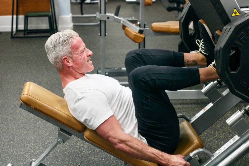 Jason Langley performs a leg press at the Schell Brothers main gym in Rehoboth Beach, where he works out and trains people using the Antonio Personal Training System by Chris Antonio. AARON R. MUSHRUSH PHOTOS