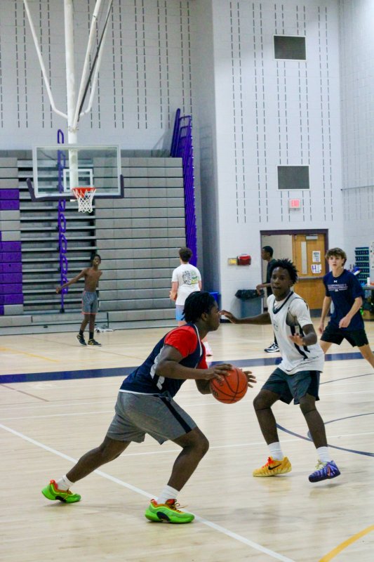 Junior Sebastian Paul begins to drive by sophomore Farmar Amisial.