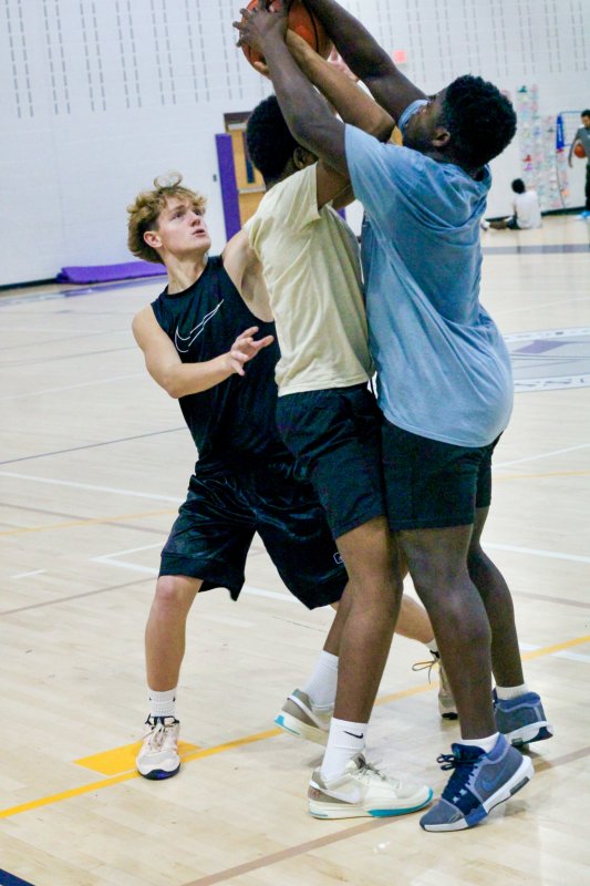 Freshman WIll Scudder, left, double teams Owen Jean and Abi Cenou.