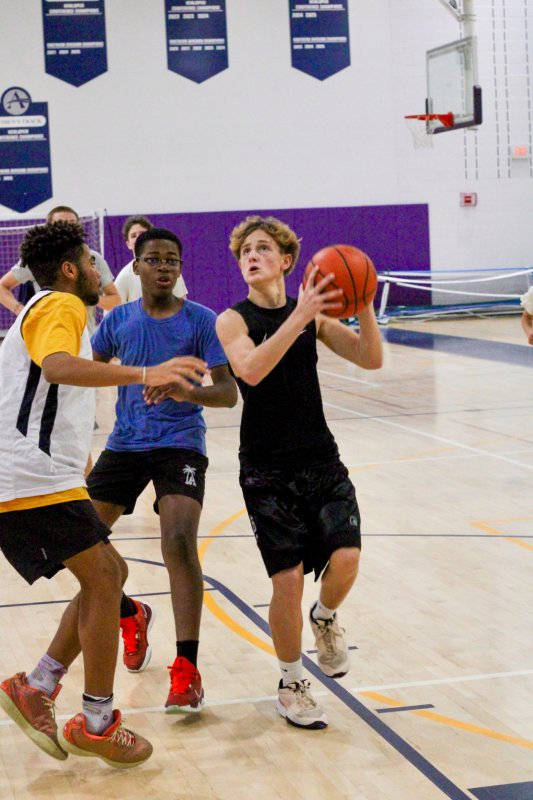 Freshman Will Scudder goes up against Noah Bailey after passing sophomore Jean-McKinny Platel.