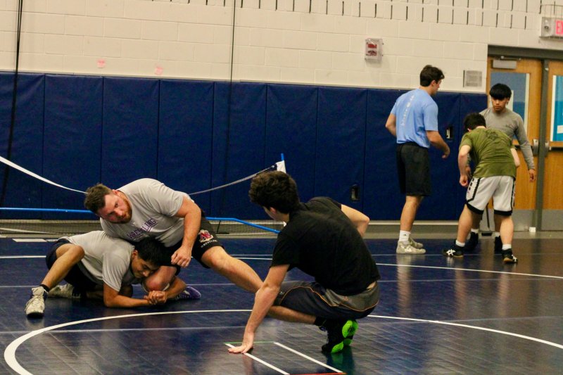 Head coach Billy Ott shows William Hendershot a move on Elean Roblero.