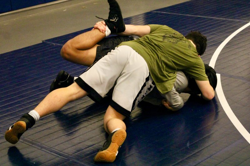 Charlie Bowman pushes with his right arm and pulls with his left during a drill on Cleverson Ortiz.