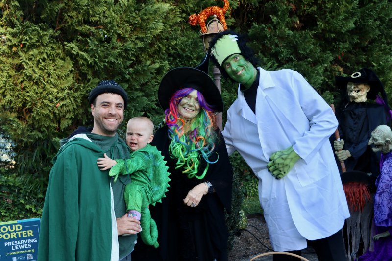 Sean Klein, left, is holding Ava, who wasn’t too happy to see a witch and Frankenstein, aka Kelly and Joe Lynch. The Lynches always have one of the most colorful Halloween displays on Kings Highway.