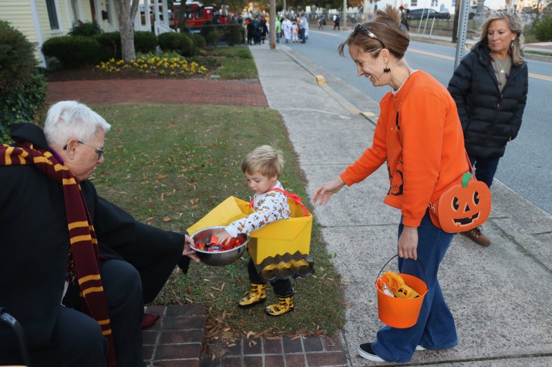Kathy Edwards, left, gives candy to Cirdan Lyter and mom Tori.