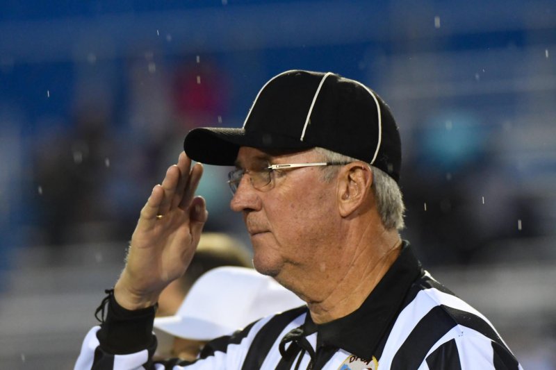 Tom Macleish, retired state police superintendent, works a football game as an official. DAVE FREDERICK PHOTOS