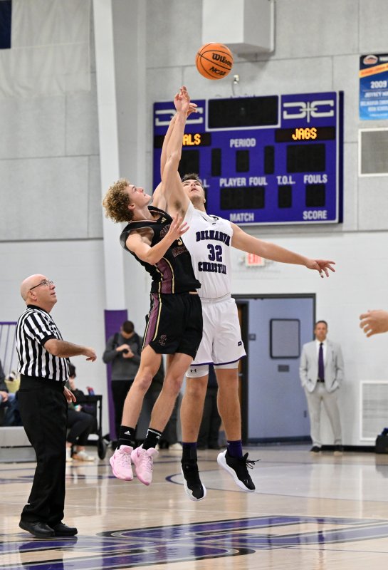 Royals forward Andrew Collins jumps ball against Joshua Travers.