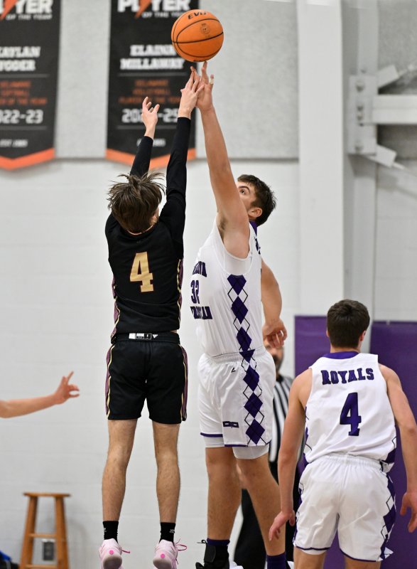 Royals forward Andrew Collins, right, blocks the shot of the Jags’ Jacob Graves.