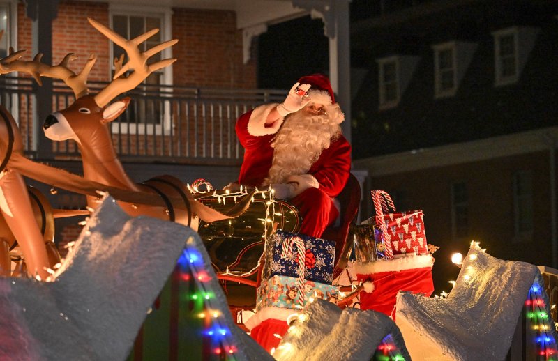 Santa waves to the crowd as his sleigh takes him around The Circle to conclude the annual Georgetown Christmas parade. DAN COOK PHOTOS