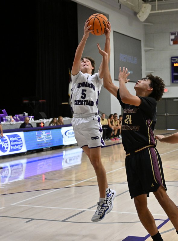 Royals junior guard Caleb Holloway snags a rebound for the home squad.