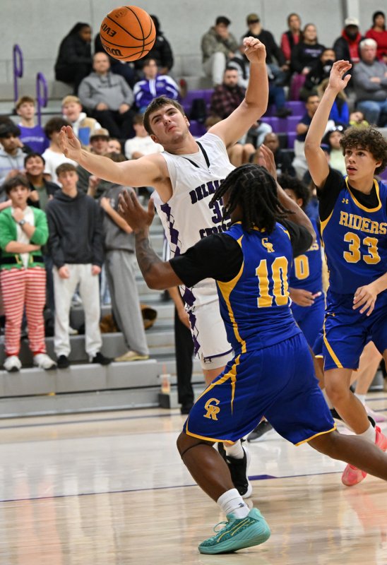 Royals senior Andrew Collins snags a rebound in the first quarter.