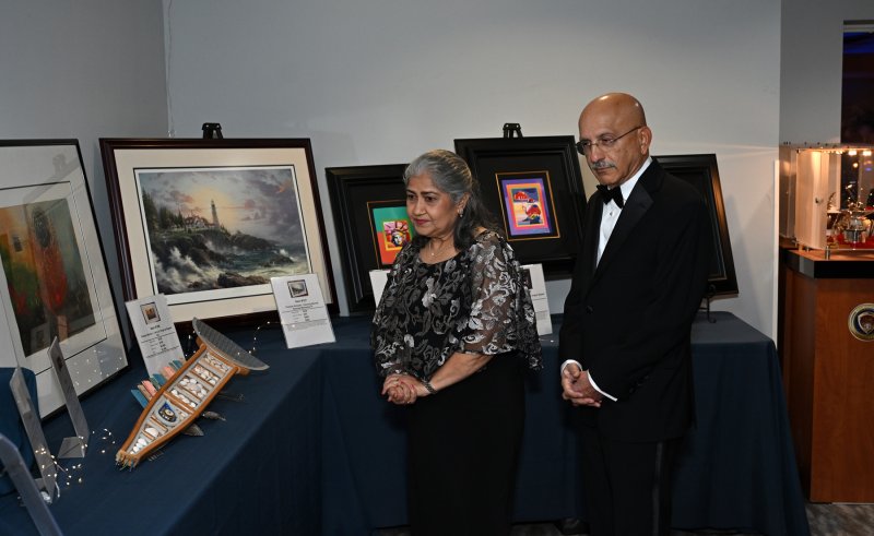 Nutan and Nikhil Divecha look over the silent auction items.
