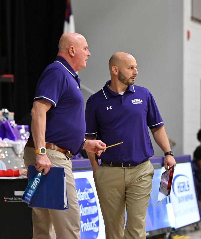 New head coach Pat Woods, right, confers on a defense with assistant Tom Pedersen.