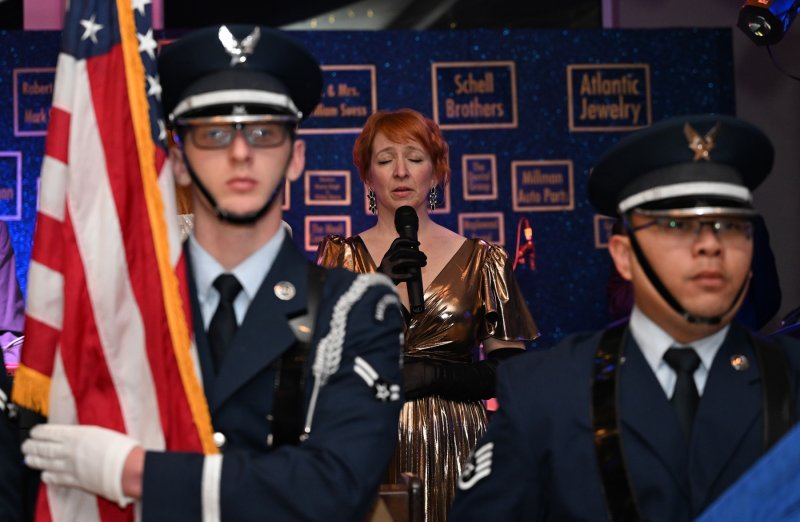 The Funsters singer Nancy Curry performs the national anthem.