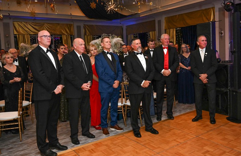 Standing for the presentation of the colors are (l-r) Sen. Russ Huxtable, D-Lewes; former Speaker of the House Pete Schwartzkopf; Kelly Zolper and husband Bill Zolper, Dewey Beach town manager; Steve Smyk, former state representative; Rod McGuinness; and Sen. Eric Buckson, R-Dover South.