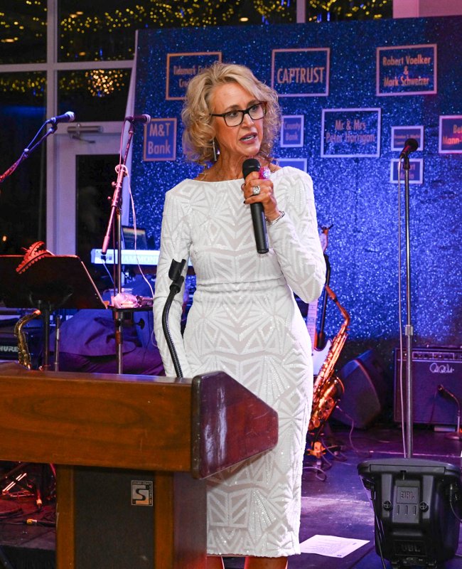Harry K Foundation Executive Committee Vice President Tarrie Miller serves as emcee for the event.