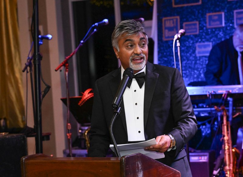 Harry Keswani tells attendees about the backpack program to fight childhood hunger.